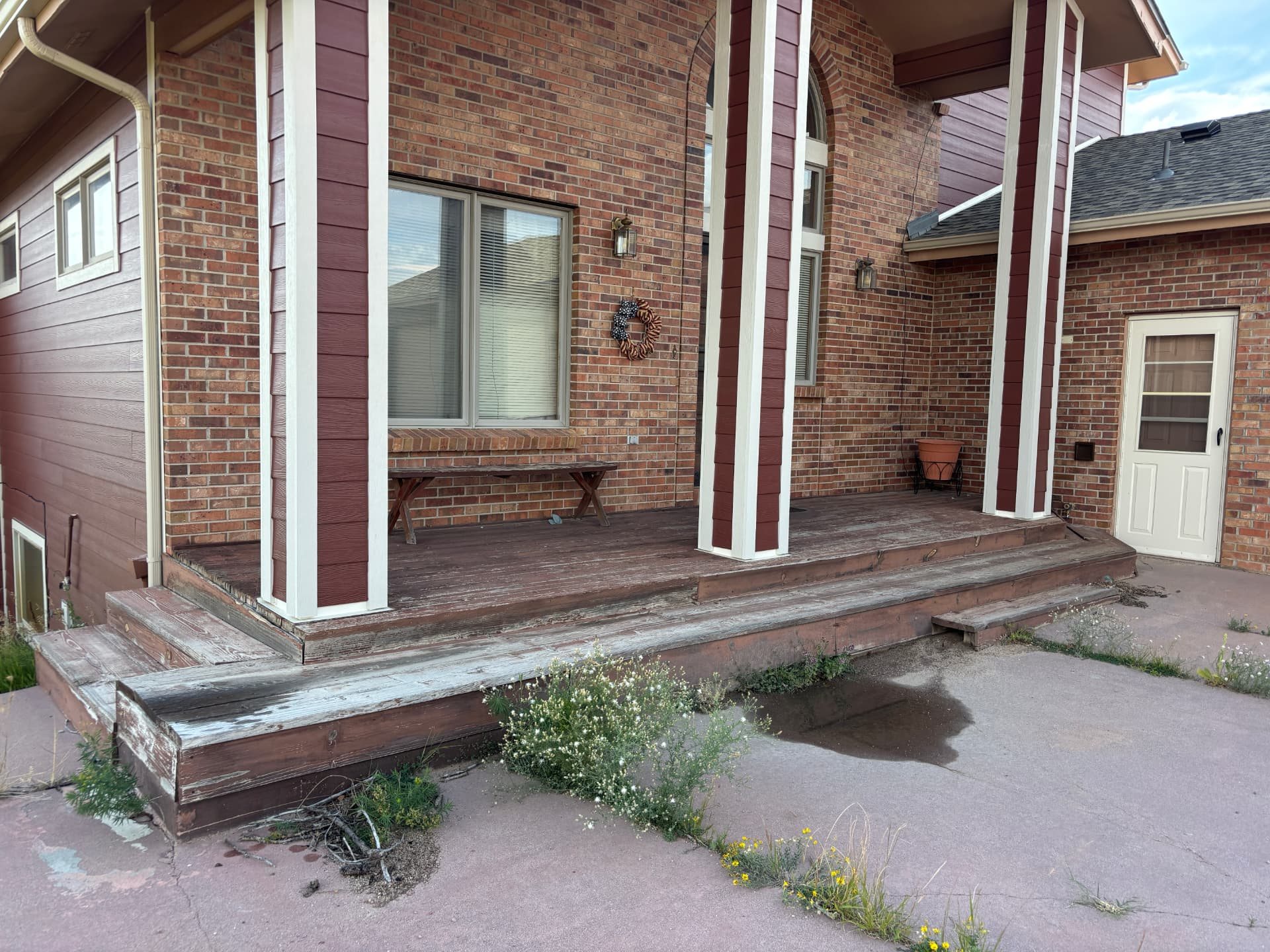 Weathered wooden porch and steps before replacement